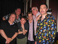 Author/Comedian Neil Mullarkey in flowered shirt with comedy team.
